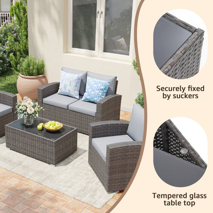 Set da conversazione in rattan per 4 persone con cuscini grigi e tavolo da esterno in vetro temperato