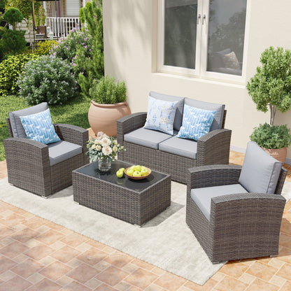 Set da conversazione in rattan per 4 persone con cuscini grigi e tavolo da esterno in vetro temperato