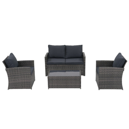 Set da conversazione in rattan per 4 persone con cuscini grigi e tavolo da esterno in vetro temperato