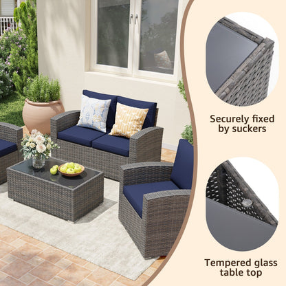 Set da conversazione in rattan per 4 persone con cuscini grigi e tavolo da esterno in vetro temperato