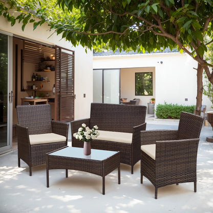 Set di mobili da esterno da 4 pezzi con cuscini, set da conversazione in vimini e tavolino da caffè in vetro