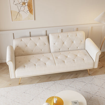 Un divano letto lungo 69,7 pollici rivestito in tessuto di velluto beige, con finiture a borchie e accompagnato da un cuscino coordinato.