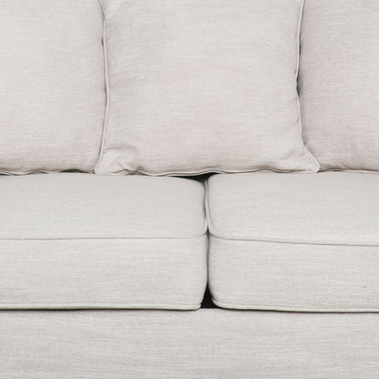 Divano a due posti beige imbottito con cuscini e gambe in legno