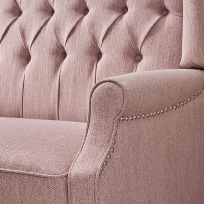 Poltrona reclinabile imbottita oversize Blush con schienale a ali e poggiapiedi, schienale con bottoni trapuntati e dettagli con borchie