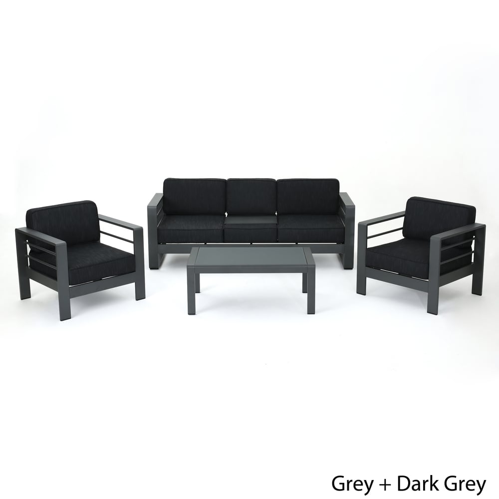 Set di divani da esterno Cape Coral in alluminio temperato e vetro, 4 pezzi, con cuscini, di Christopher Knight Home