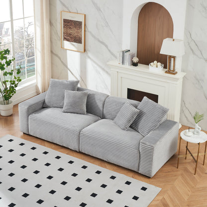 Divano a 4 posti in velluto a coste grigio con cuscini decorativi