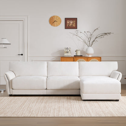 Divano modulare a L Roomfitters con ampia seduta in ciniglia, caricabatterie USB di tipo C e pouf, braccioli a petalo, schiuma alta